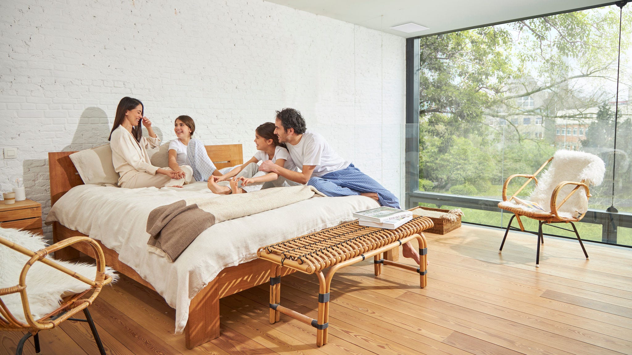 Eine vierköpfige Familie genießt ein gut belüftetes Schlafzimmer